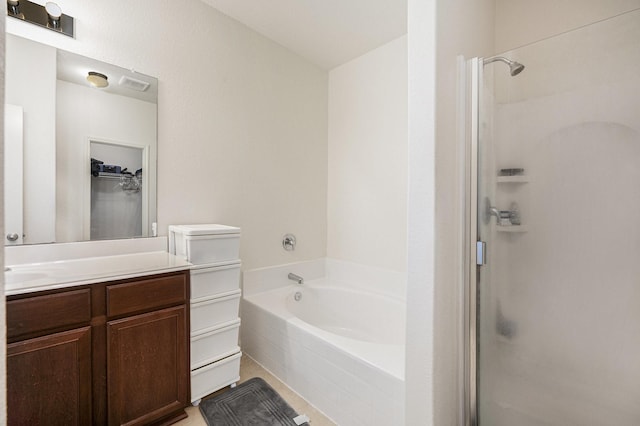 bathroom with vanity and shower with separate bathtub