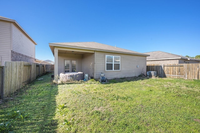 rear view of house featuring a lawn