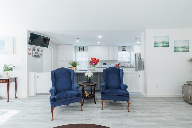 sitting room featuring light hardwood / wood-style flooring