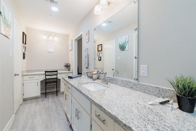 bathroom featuring vanity and hardwood / wood-style floors