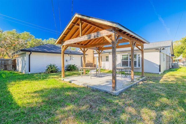 back of house with a yard and a patio area