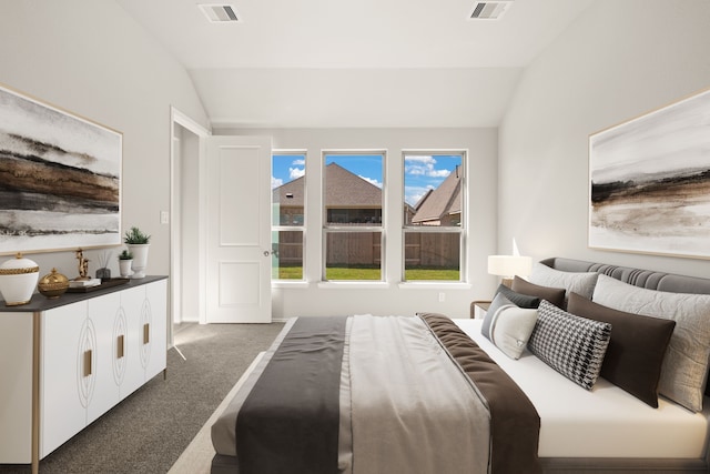 carpeted bedroom with lofted ceiling