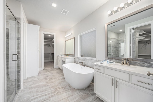 bathroom featuring vanity and separate shower and tub