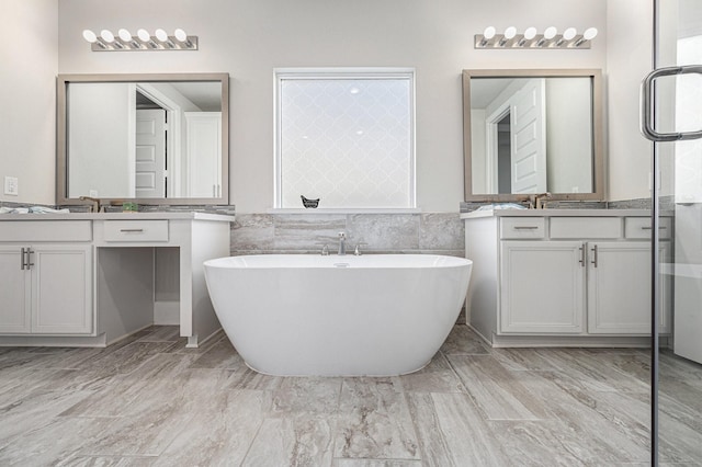 bathroom with tile walls, vanity, and a bathing tub