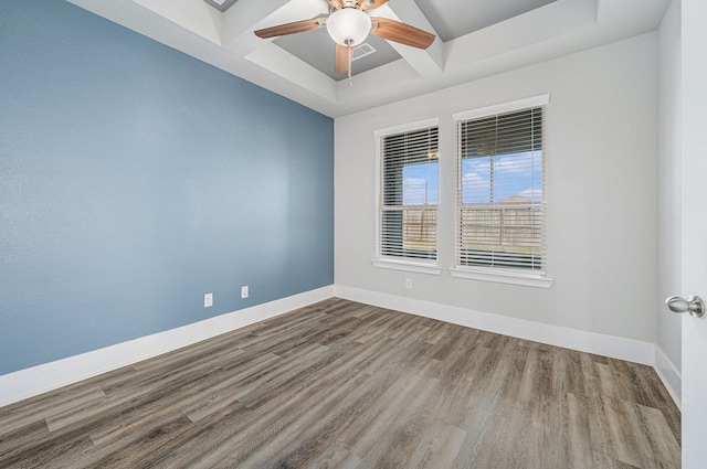 spare room with coffered ceiling, ceiling fan, and hardwood / wood-style flooring