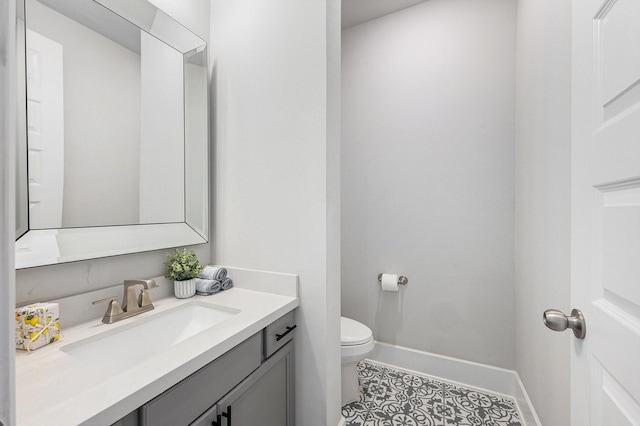 bathroom featuring tile patterned floors, toilet, and vanity