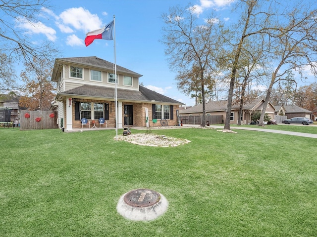 back of house featuring a fire pit and a lawn