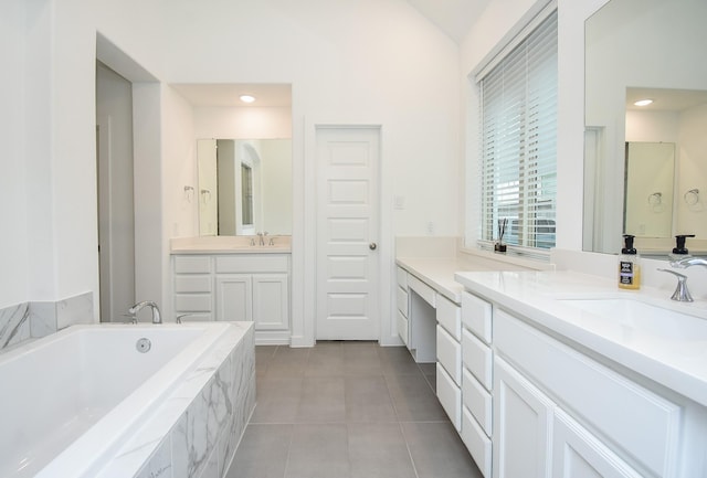 bathroom featuring vanity, tile patterned flooring, lofted ceiling, and a relaxing tiled tub