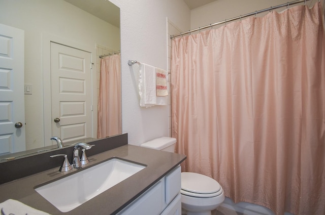 bathroom featuring toilet and vanity