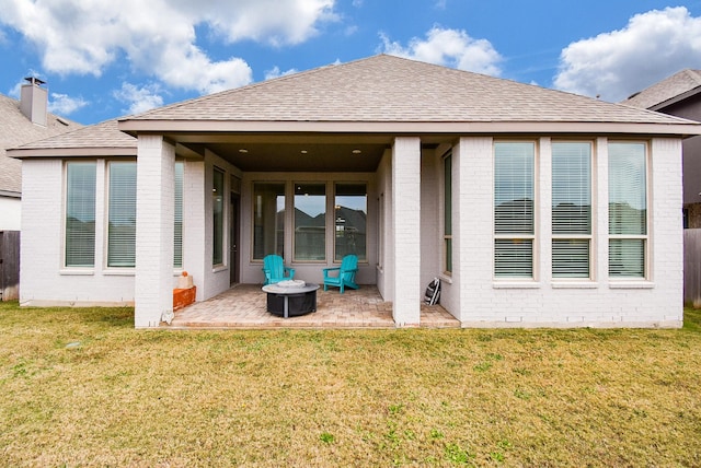 rear view of house featuring a yard and a patio