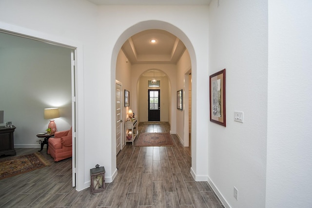 hallway featuring a raised ceiling