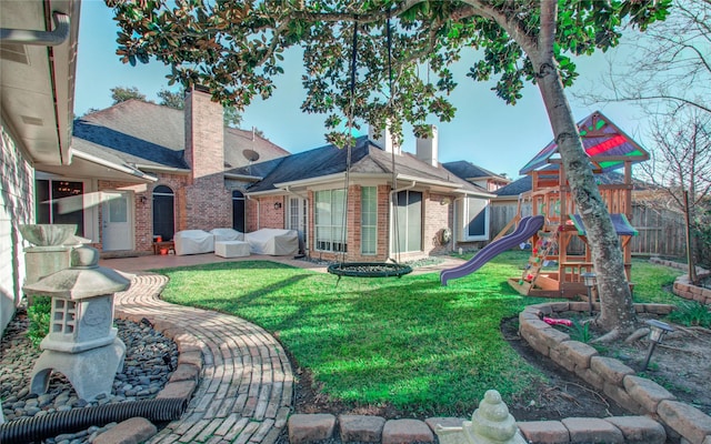 rear view of property with a playground and a yard