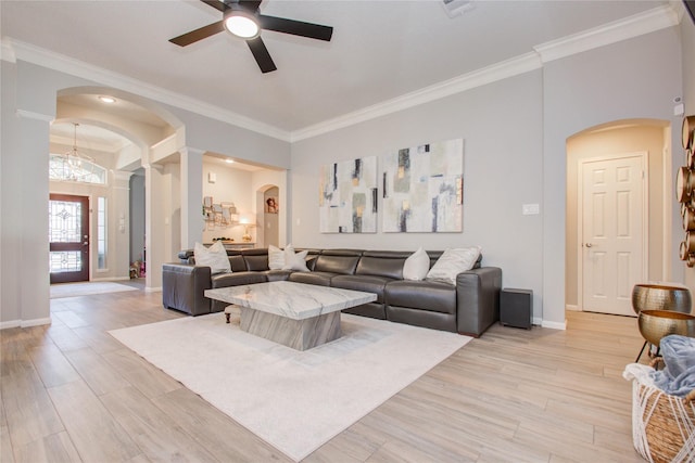 living room featuring ceiling fan with notable chandelier, crown molding, and light hardwood / wood-style flooring