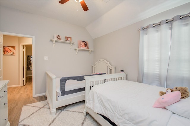 bedroom featuring light wood-type flooring, ceiling fan, and vaulted ceiling