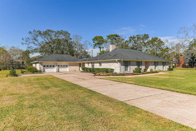 single story home featuring a garage and a front lawn