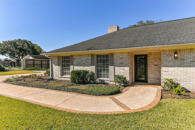 entrance to property featuring a lawn