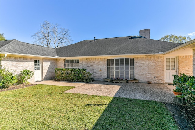 back of house featuring a patio area and a yard