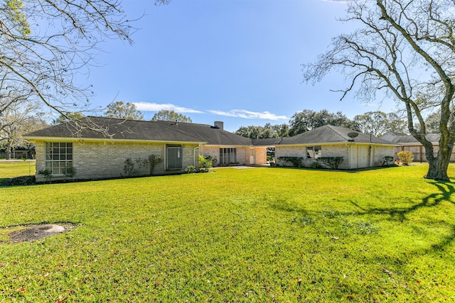 rear view of house with a yard