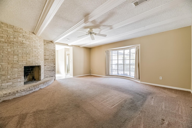 unfurnished living room featuring ceiling fan, carpet, a fireplace, a textured ceiling, and beamed ceiling