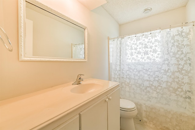 bathroom featuring a textured ceiling, toilet, and vanity