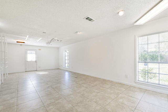 spare room with plenty of natural light and light tile patterned flooring