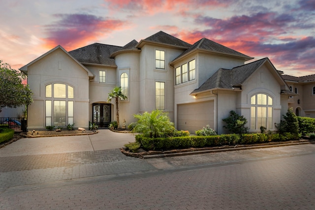 4 Mariners Ln, Kemah, TX 77565 - french provincial home featuring french doors, stucco siding, decorative driveway, and an attached garage