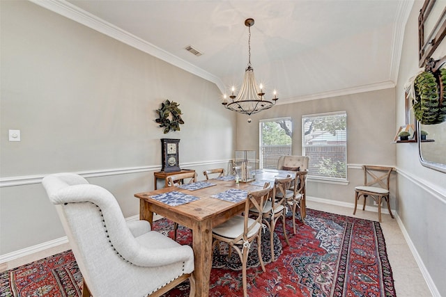 dining room with crown molding, light tile patterned floors, and an inviting chandelier