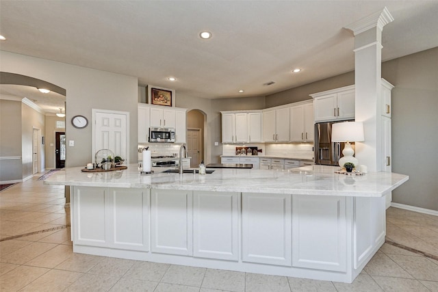 kitchen with sink, light tile patterned flooring, white cabinetry, and stainless steel appliances