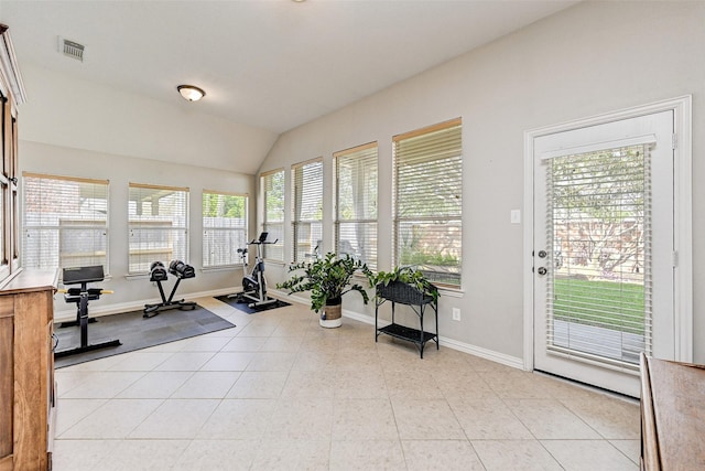 workout area with light tile patterned floors and lofted ceiling