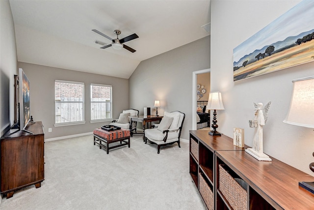 sitting room featuring light colored carpet, vaulted ceiling, and ceiling fan