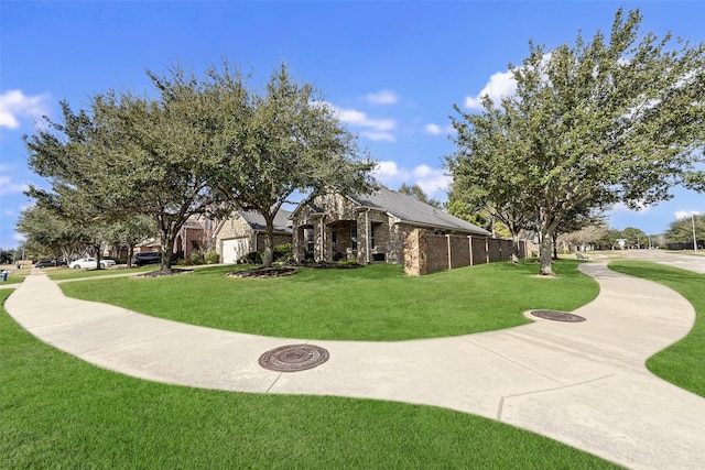 view of property's community with a lawn