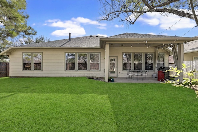 back of house featuring a patio area and a lawn