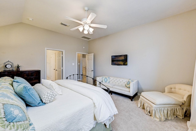 carpeted bedroom with ceiling fan and vaulted ceiling