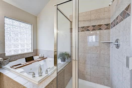 bathroom with separate shower and tub and vaulted ceiling