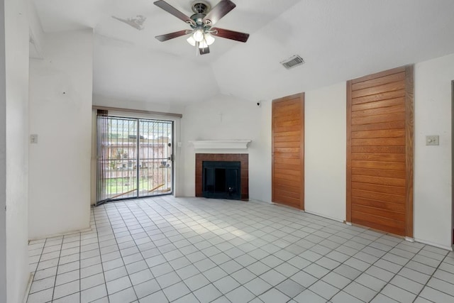 unfurnished living room with ceiling fan, light tile patterned flooring, lofted ceiling, and a tile fireplace