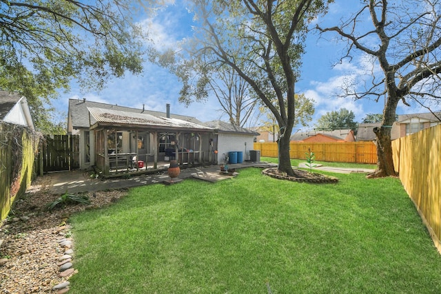 back of house with a patio area and a lawn