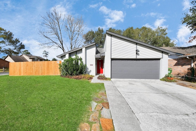 view of front of home featuring a garage and a front lawn