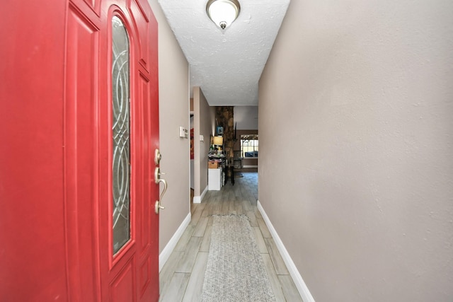 interior space featuring a textured ceiling and light hardwood / wood-style flooring