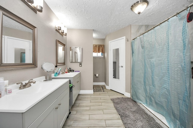 bathroom featuring vanity and a textured ceiling