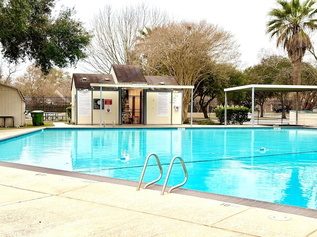 view of pool featuring an outbuilding