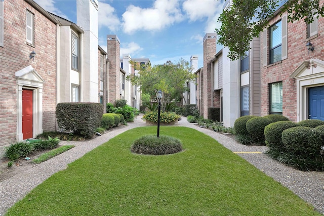 view of home's community with a lawn