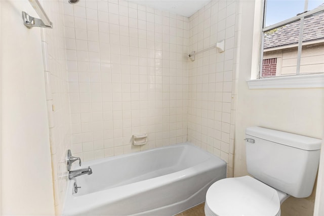 bathroom with tub / shower combination and toilet