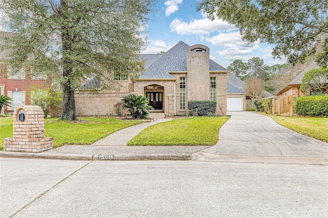 view of front of property featuring a garage and a front yard