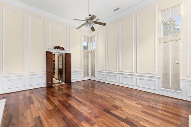 unfurnished living room with dark wood-type flooring, ceiling fan, and ornamental molding