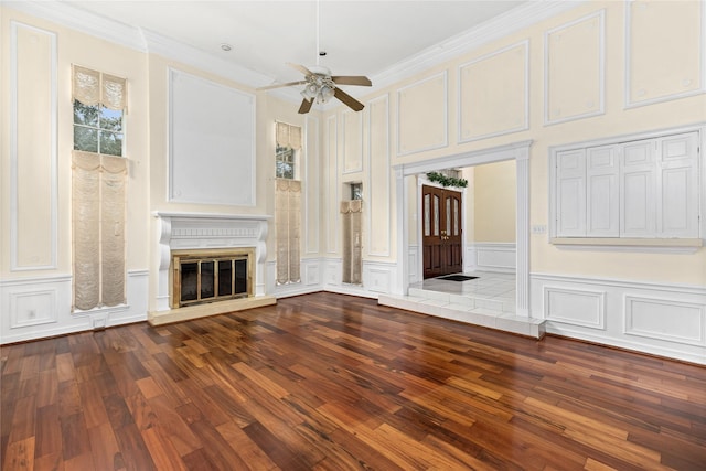 unfurnished living room featuring ceiling fan, wood-type flooring, and crown molding