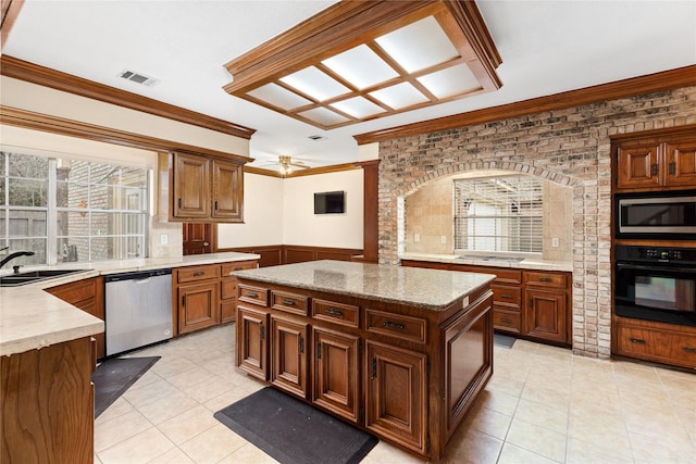 kitchen with black appliances, a center island, sink, ornamental molding, and plenty of natural light