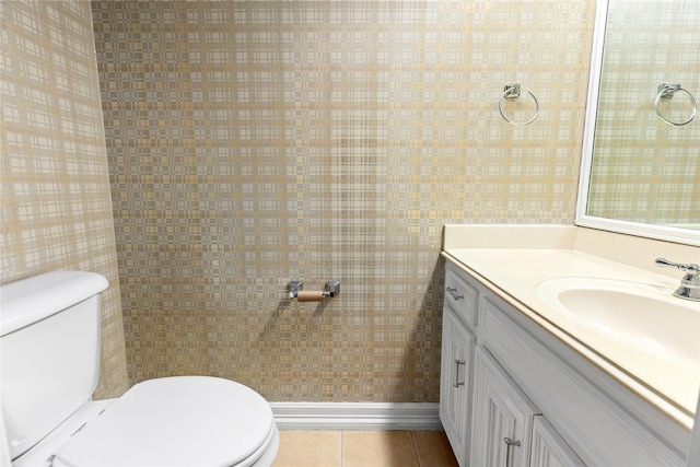 bathroom with toilet, tile patterned floors, and vanity