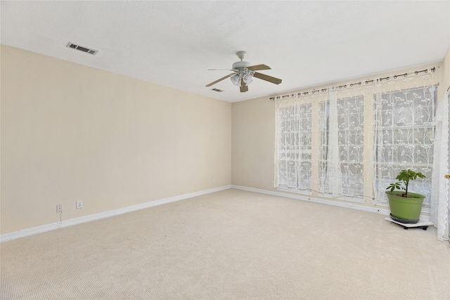 unfurnished room with ceiling fan and carpet floors