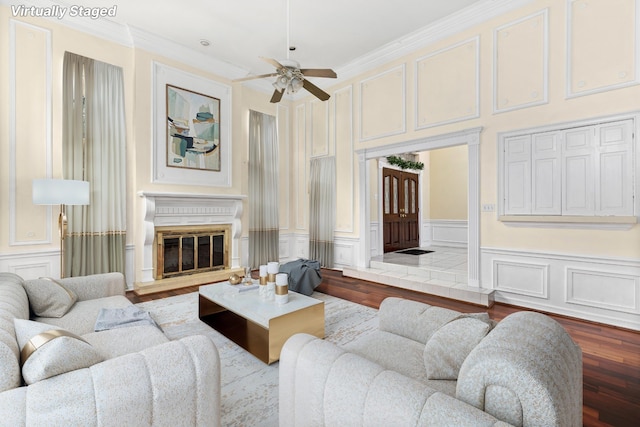 living room with hardwood / wood-style flooring, ornamental molding, and ceiling fan