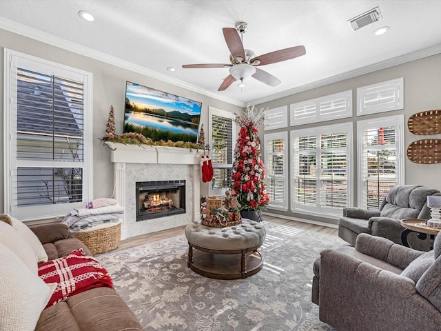 living room featuring ceiling fan, hardwood / wood-style floors, and crown molding